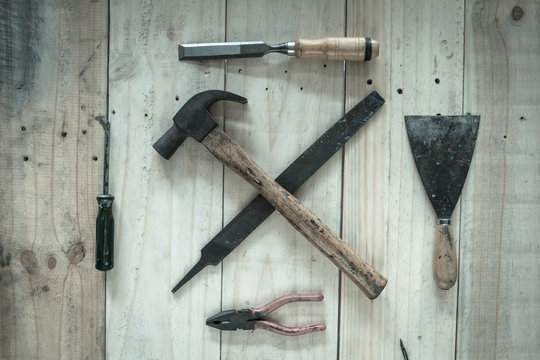 Assorted work tools on wood background,vintage image