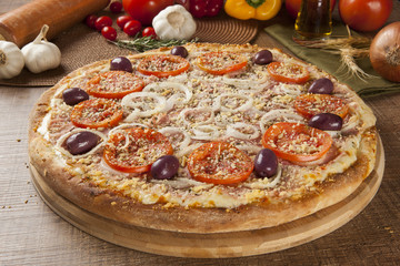 ham and tomato pizza  on the table