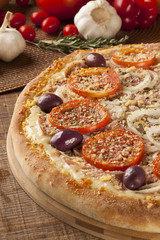 ham and tomato pizza  on the table