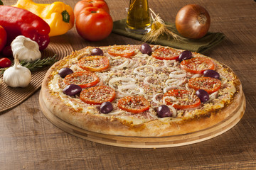 ham and tomato pizza  on the table