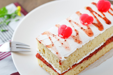 Strawberry cake with heart candies for sweet valentines.