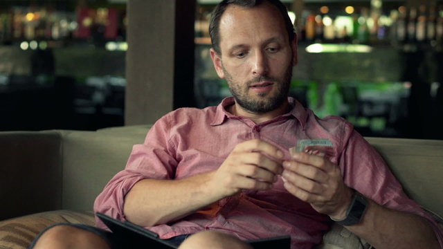 Young man paying for bill in restaurant
