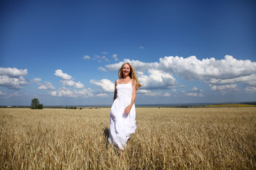 Fototapeta na wymiar Full-length portrait of a beautiful young girl in a white dress