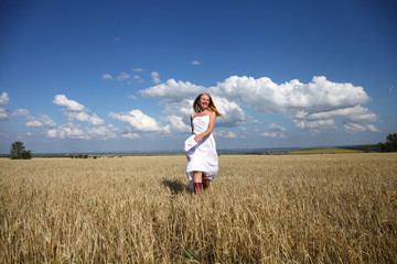 Full-length portrait of a beautiful young girl in a white dress