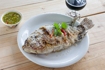 fish grilled with salt on wood background,Thai food