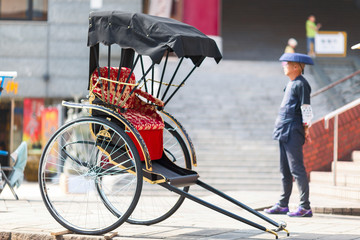 Japanese rickshaw man awaiting for the customers. Nagasaki - obrazy, fototapety, plakaty