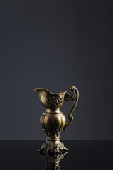 Fototapeta na wymiar antique metal kettle on a dark background 