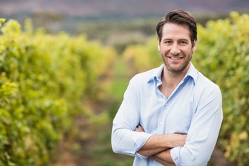 Happy vintner with crossed arms