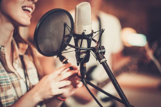 Woman singer in a recording studio
