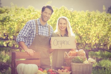 Smiling farmers couple looking at the camera