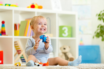 happy child holding elefant toy
