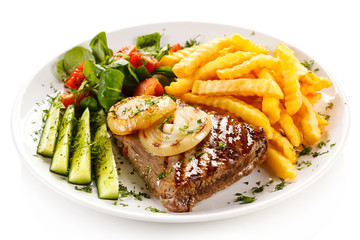 Grilled steak, French fries and vegetables 