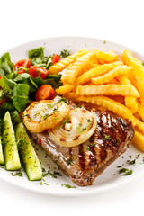 Grilled steak, French fries and vegetables 