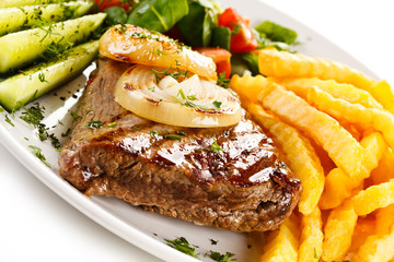 Grilled steak, French fries and vegetables 