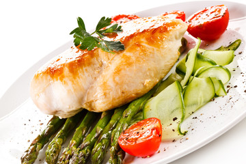 Roast chicken fillet and vegetables on white background 