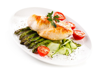Roast chicken fillet and vegetables on white background 