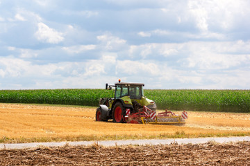 Agriculture - tractor ploughing at the field