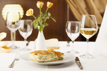 Traditional pie with cheese and vegetable./Close up of pie with cheese and vegetable. Restaurant meal. Pie with herbs