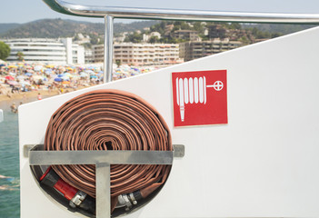 Fire hose and sign onboard the boat.