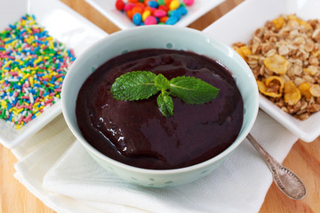 Brazilian dessert Acai pulp with muesli, sprinkles