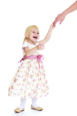 little girl clings to her mother's finger