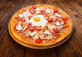 Delicious pizza with mushrooms, bacon and egg