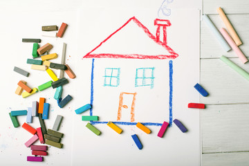 Design Concept for real estate - color dry pastel on a white and wooden background. Top view.