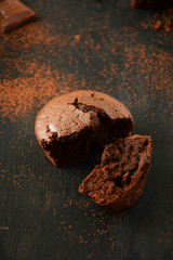 Homemade chocolate muffin on dark wooden background
