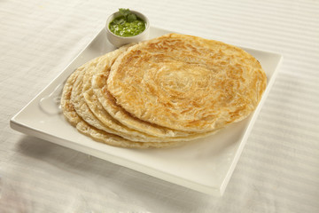 Plain paratha puri served with freshly diced corriander in green