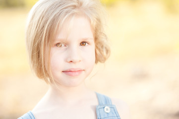 Fototapeta premium Closeup portrait of cute kid girl outdoors