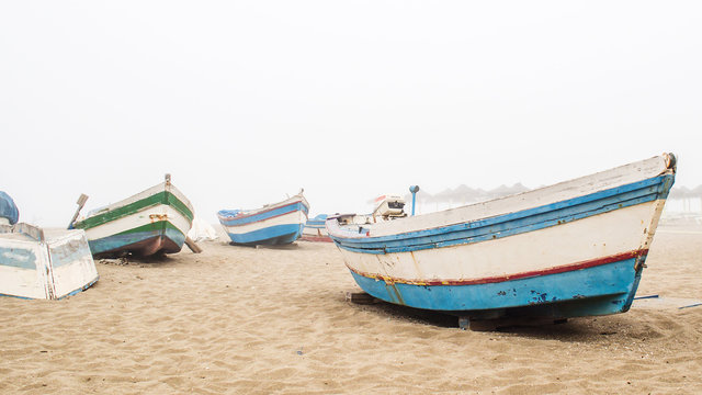 fishing boats in misty morning