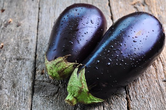 organic eggplants on a wooden background