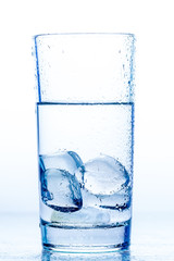 elegant glass with water and ice on a white background