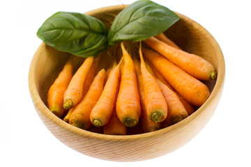 fresh carrots in wooden plate on white background. vegetarian food