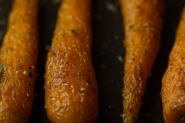 whole roasted carrots with spices in a skillet. Vegetarian healthy food