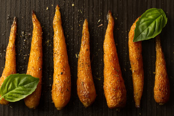whole roasted carrots with spices in a skillet. Vegetarian healthy food