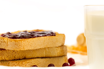 fresh french toast with honey and jam on a white plate with berries on a white background. healthy diet