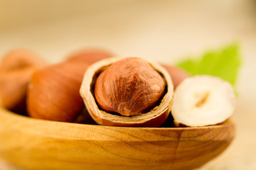 hazelnuts with leaves on old wooden background. Healthy vegetarian food