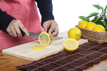 woman cutting lemon in clean environment