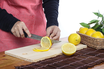 woman cutting lemon in clean environment