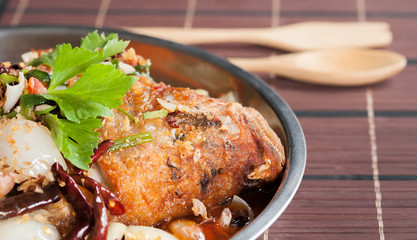 fried fish with fresh herbs and sweet spicy sauce on wood and sp