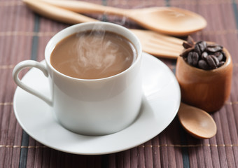 cup of coffee and Wooden Spoon on wood table