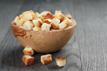 homemade croutons from white bread in wood bowl