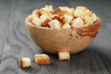 homemade croutons from white bread in wood bowl