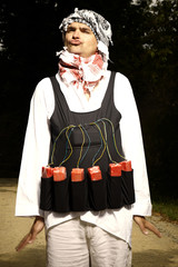 Funny man with vest of plastic explosives standing in park