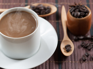cup of coffee and Wooden Spoon on wood table