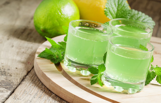 Citrus juice with soda in a glass on a wooden background, select