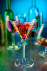 Martini glass against other glasses with alcohol
