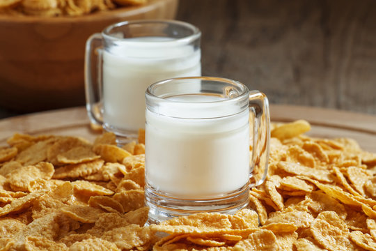 Milk in a cup and corn flakes, selective focus