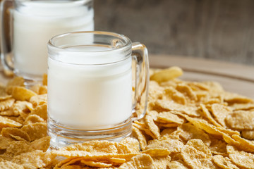 Milk in a cup and corn flakes, selective focus